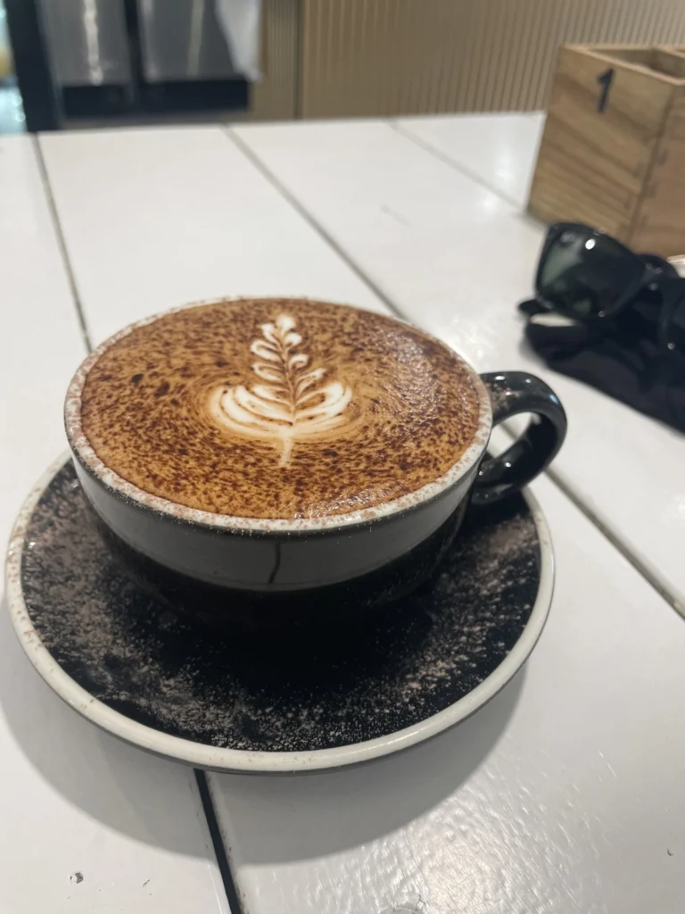 A flat white poured with Sunny Coast Coffee